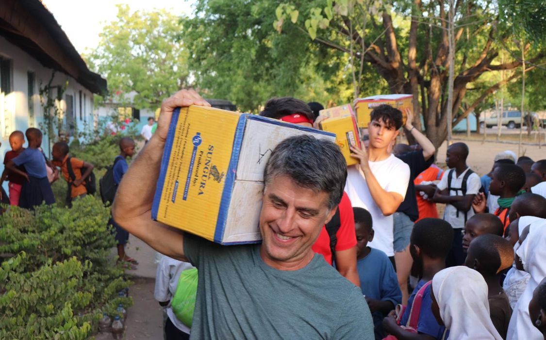 Boxes of school books being carried in for donation