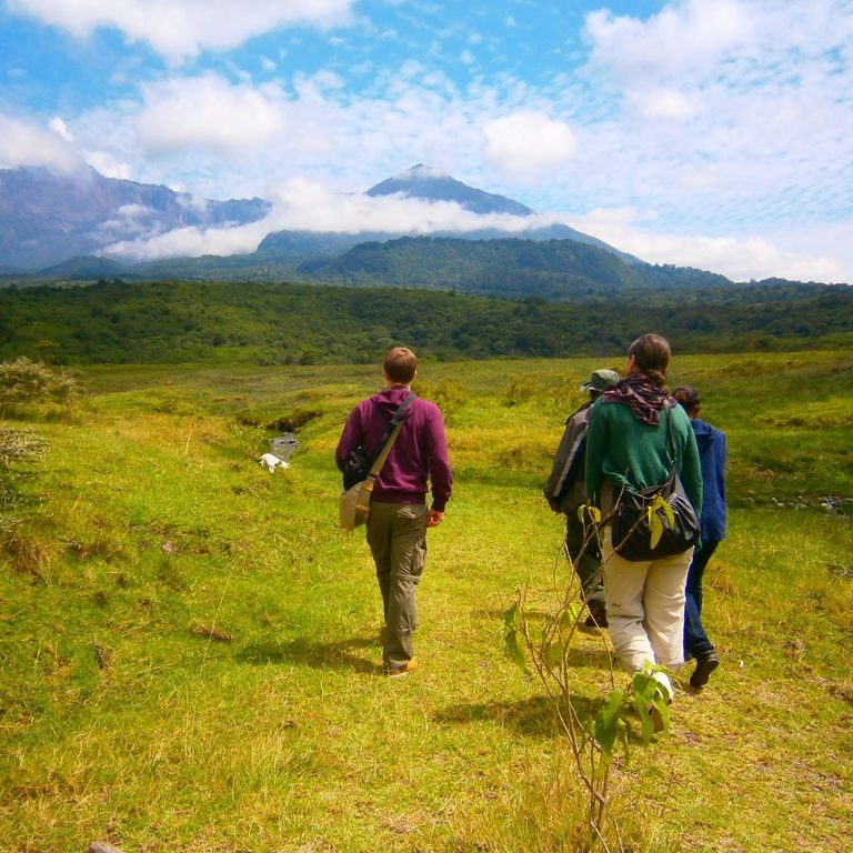 Two hikers on the open slopes below Mount Meru