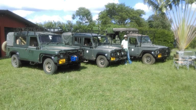 Land Rovers parked on the lawn, ready for safari