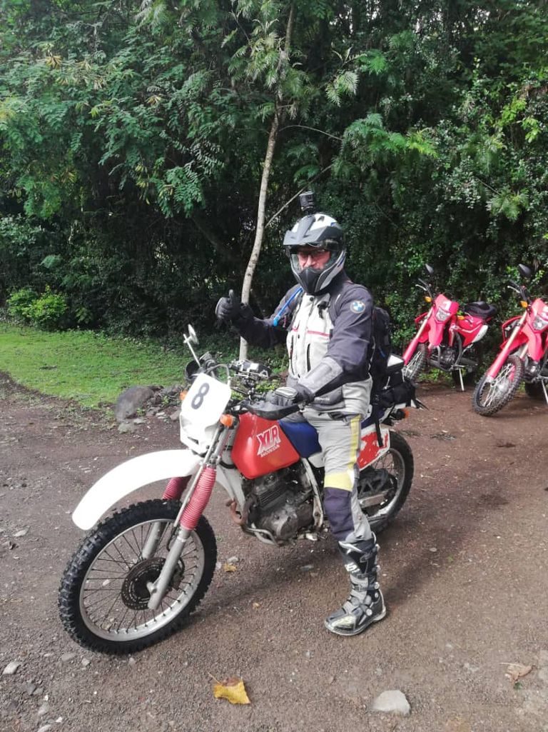A rider on a trail motorcycle on a country track